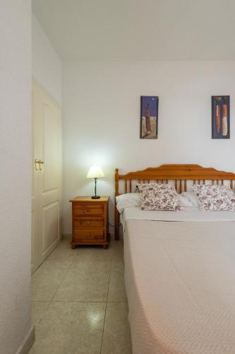 a bedroom with two beds and a night stand with a lamp at Zafiro Calpe by Concept Flats in Ifach