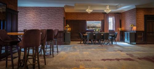 a dining room with a table and chairs in a room at Glenroyal Hotel in Maynooth
