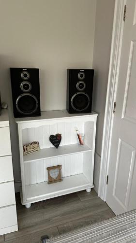 a room with two speakers on a white shelf at Studio Apartment in Letterkenny