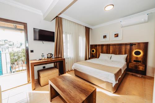 a hotel room with a bed and a table at The Lume Boutique Hotel & Restaurant & Spa in Bodrum City