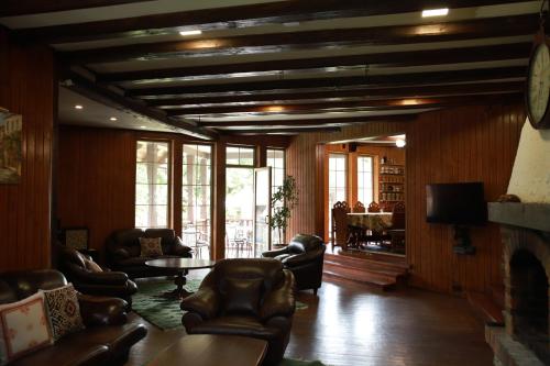 a living room with leather chairs and a table at Маєток Ліс і Гори in Bukovel
