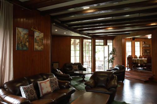 a living room with leather chairs and a table at Маєток Ліс і Гори in Bukovel
