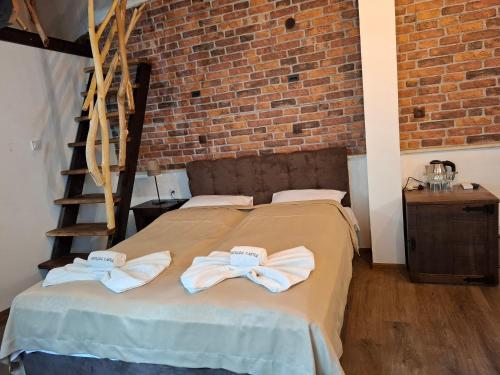 a bedroom with a bed with towels on it at Horlog Castle in Trigrad