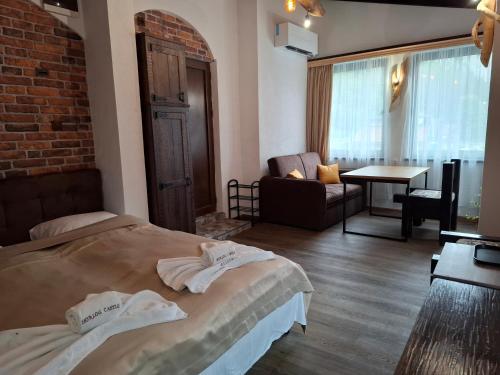 a hotel room with a bed and a living room at Horlog Castle in Trigrad