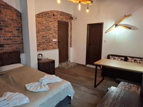a room with a bed and a table and a piano at Horlog Castle in Trigrad