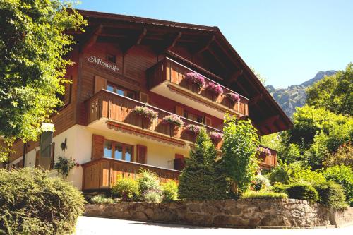 a building with balconies and flowers on it at Chalet Miravalle 2 in Wengen