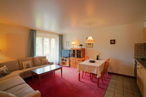 a living room with a couch and a table at Chalet Miravalle 2 in Wengen