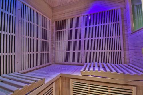 an empty sauna with two benches in a room at Alice aux pays des merveilles in Maintenon