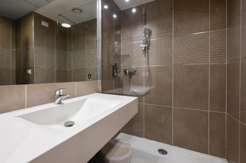 a bathroom with a sink and a shower at B&B Hotel Trento in Trento
