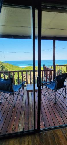 a porch with two chairs and a table on the beach at Xai Xai Mozambique, Fish Eagle, Xai Xai Beach Front in Xai-Xai