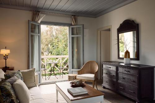a living room with a couch and a table at Porto Kea Suites by Sandglass in Korissia