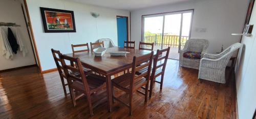 a dining room with a wooden table and chairs at Xai Xai Mozambique, Fish Eagle, Xai Xai Beach Front in Xai-Xai