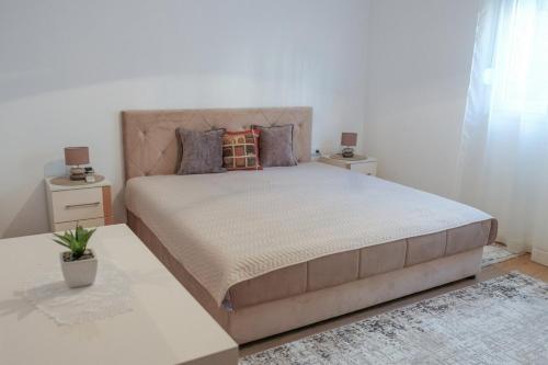 a bedroom with a large bed with two night stands at NIDA Apartment in Ulcinj