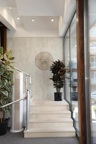 a staircase in a building with a potted plant at Hotel Afa in Pristina