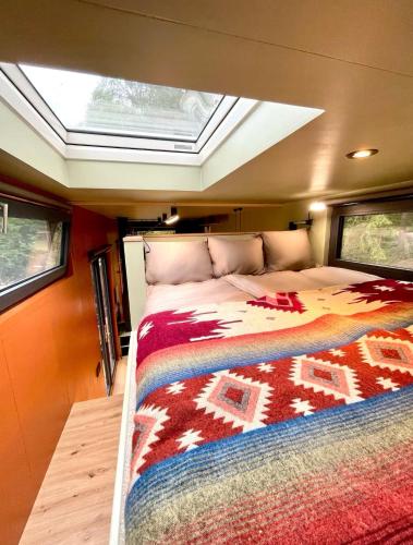 a large bed in the middle of a room at Freyja Summer Forest Retreat Cabin with Private Outdoor Tub and Lakeside Views in Örby