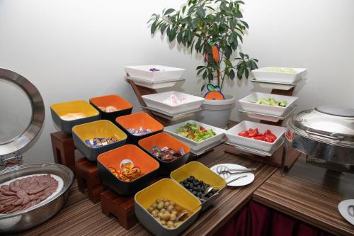 a table with several trays of food on it at Hotel Afa in Pristina