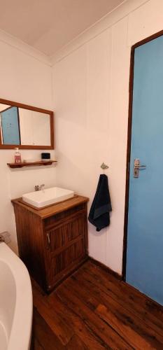 a bathroom with a sink and a mirror at Xai Xai Mozambique, Fish Eagle, Xai Xai Beach Front in Xai-Xai