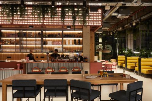 a restaurant with tables and chairs and a bar at The Social Hub Barcelona Poblenou Extended Stay in Barcelona