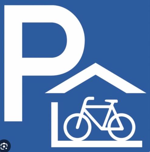 a blue sign with a bike in front of a house at Le Veenbahn in Deidenberg