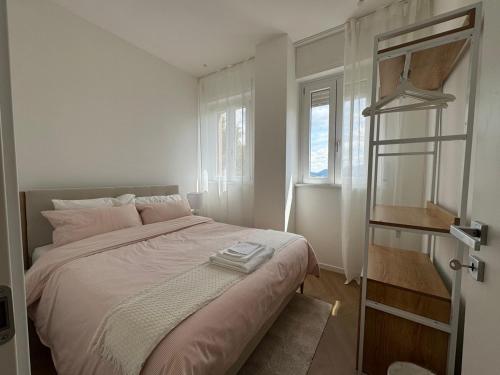 a bedroom with a bed and a window at Roccia Verde apartment in Cernobbio