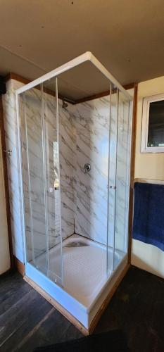 a shower with a glass enclosure in a room at Xai Xai Mozambique, Fish Eagle, Xai Xai Beach Front in Xai-Xai