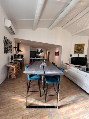 une salle à manger et un salon avec une table et des chaises dans l'établissement Villa Provence 70, à LʼIsle-sur-la-Sorgue