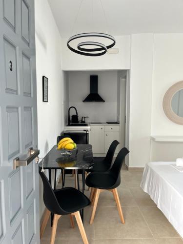 a dining room with a table and two chairs at Aeolian Breeze 3 in Tinos