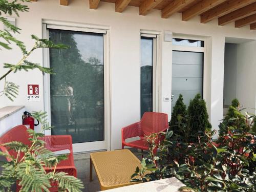 a porch with red chairs and a table at Casa Raffa in Raffa