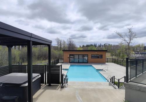 a house with a swimming pool and a building at Plateau Zen & Cosy in Gatineau