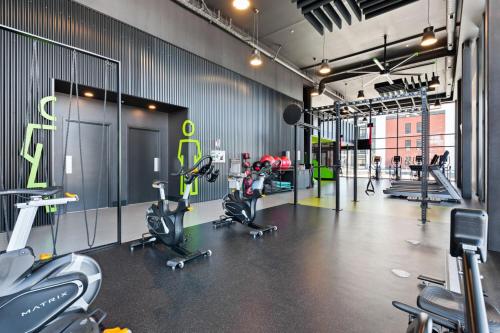 a gym with treadmills and exercise bikes in it at Plateau Zen & Cosy in Gatineau