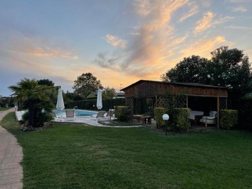 a building with a pool in a yard at Villa Ondina Versilia in Lido di Camaiore
