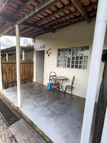 a patio with a table and chairs on a house at Pousada Veadeiros - Alto Paraiso de Goiás in Alto Paraíso de Goiás