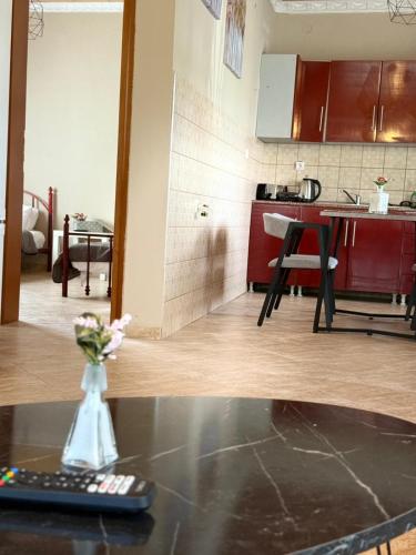a remote control sitting on a table in a kitchen at Elenora house in Nea Kalikratia