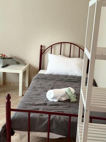 a bedroom with a bed with a ladder next to it at Elenora house in Nea Kalikratia