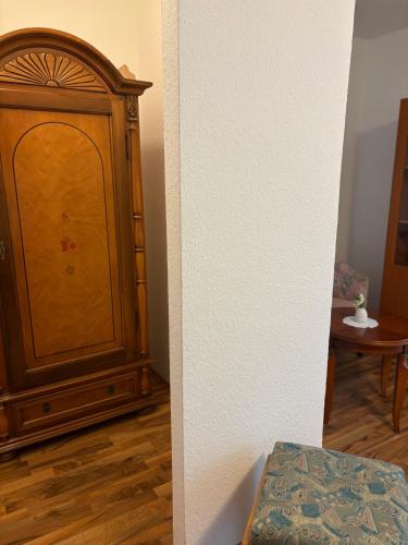 a wooden cabinet in a room with a wooden floor at Komfort Appartement Bad Pyrmont Nähe Kurpark in Bad Pyrmont