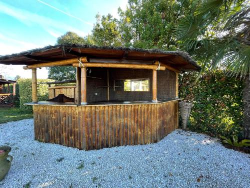 a small building with a roof on top of gravel at Villa Ondina Versilia in Lido di Camaiore