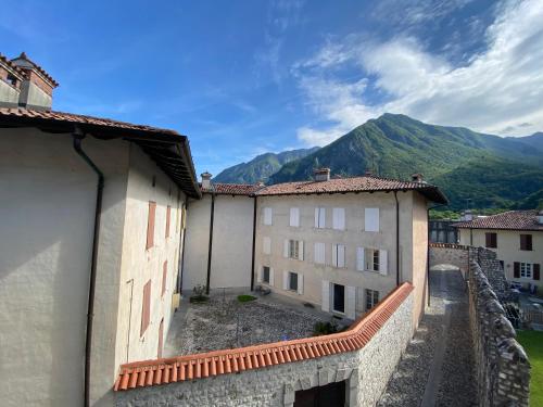 a group of buildings with mountains in the background at Affittacamere Torrione in Venzone