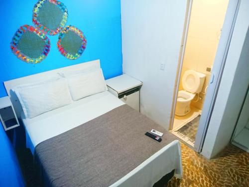 a small room with a bed and a bathroom at Pousada Sol e Mar de Pajuçara in Maceió