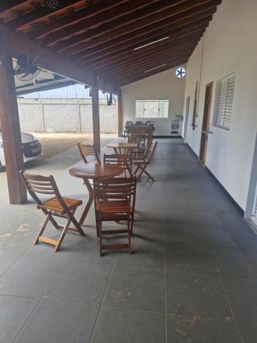 a group of tables and chairs in a building at Chacara cad club quarto de casal in Sao Jose do Rio Preto