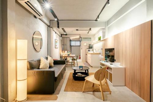 a living room with a couch and a table at Rare Bangkok Townhouse Perfect for Groups, 8 mins to Train in Bangkok