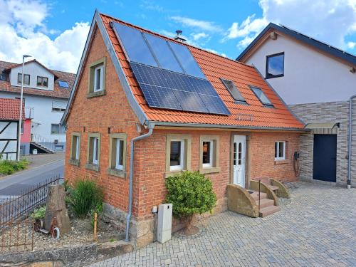 a house with solar panels on the roof at Ferienhaus Rita in Bad Bocklet