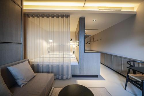 a small room with a bed and a couch at Revier Hotel Säntispark in St. Gallen