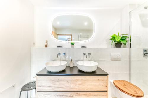 a bathroom with two sinks and a mirror at Sauna Bain Nordique Cinéma Vue Montange in Chamonix-Mont-Blanc
