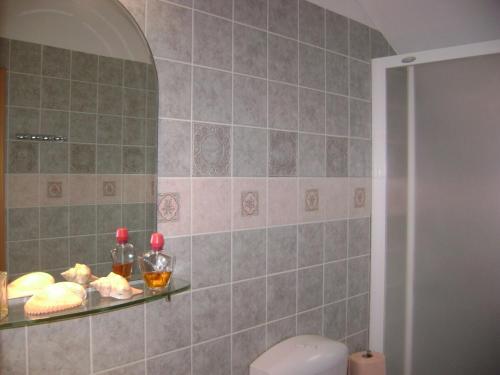 a bathroom with a shelf with food on it at Apartment ANDRIUCI in Cavtat