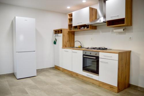 a kitchen with white appliances and a white refrigerator at Gold Wine Estate in Podlehnik