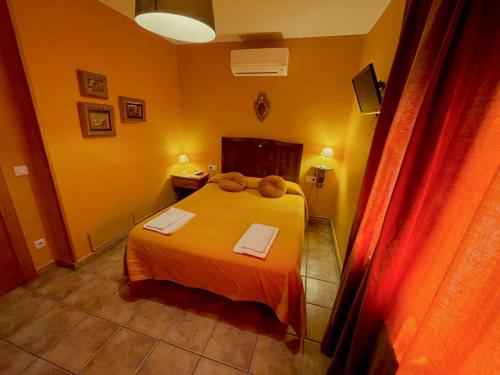 a bedroom with a bed with a teddy bear on it at Casa rural de la Abuela in Cadreita