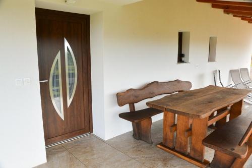 a room with a wooden table and a door at Gold Wine Estate in Podlehnik