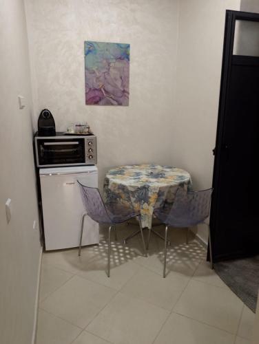 a small kitchen with a table and a stove at TheHive Residence in Fès