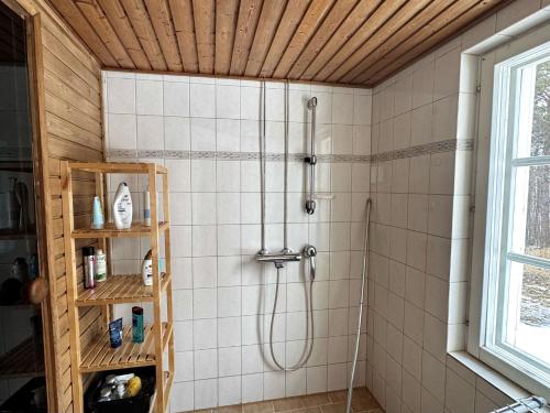 a bathroom with a shower with a shower head at Villa Lempeänranta in Pello