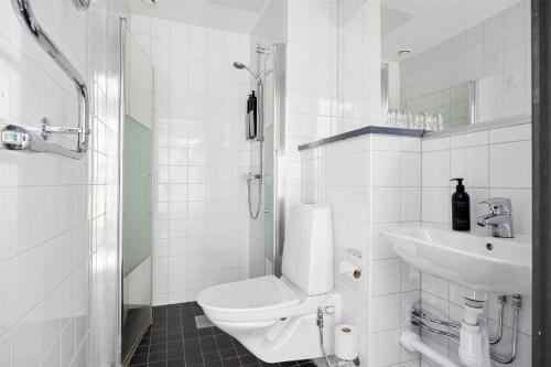 a white bathroom with a toilet and a sink at Best Western Hotel Norrkoping City in Norrköping